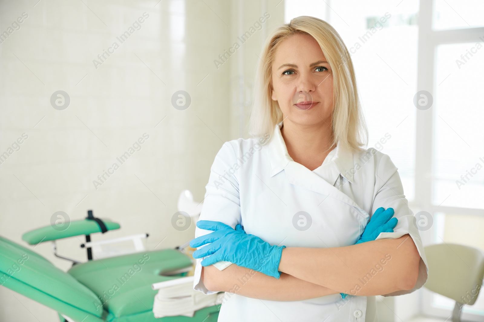 Photo of Portrait of gynecologist at workplace in clinic. Space for text