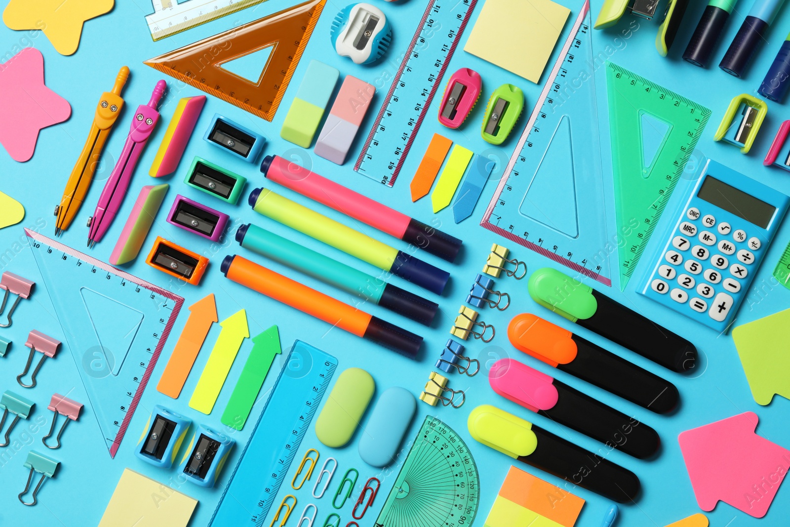 Photo of Different stationery on light blue background, flat lay. Back to school