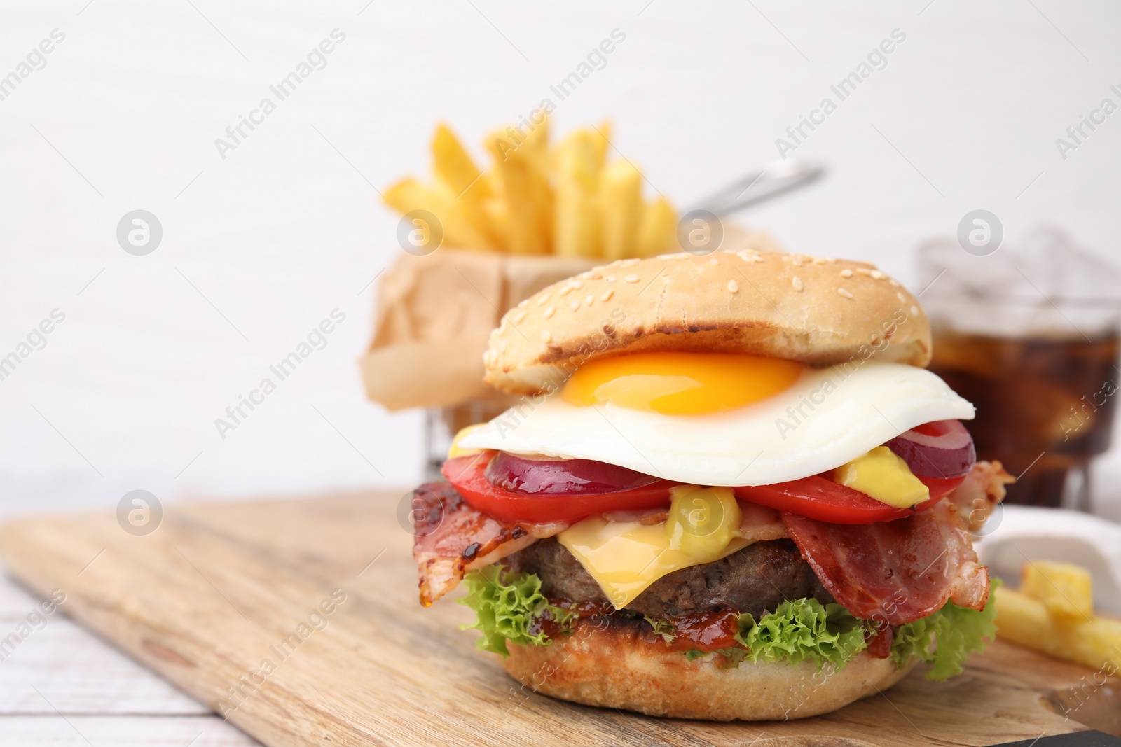 Photo of Delicious burger with fried egg on table, closeup. Space for text