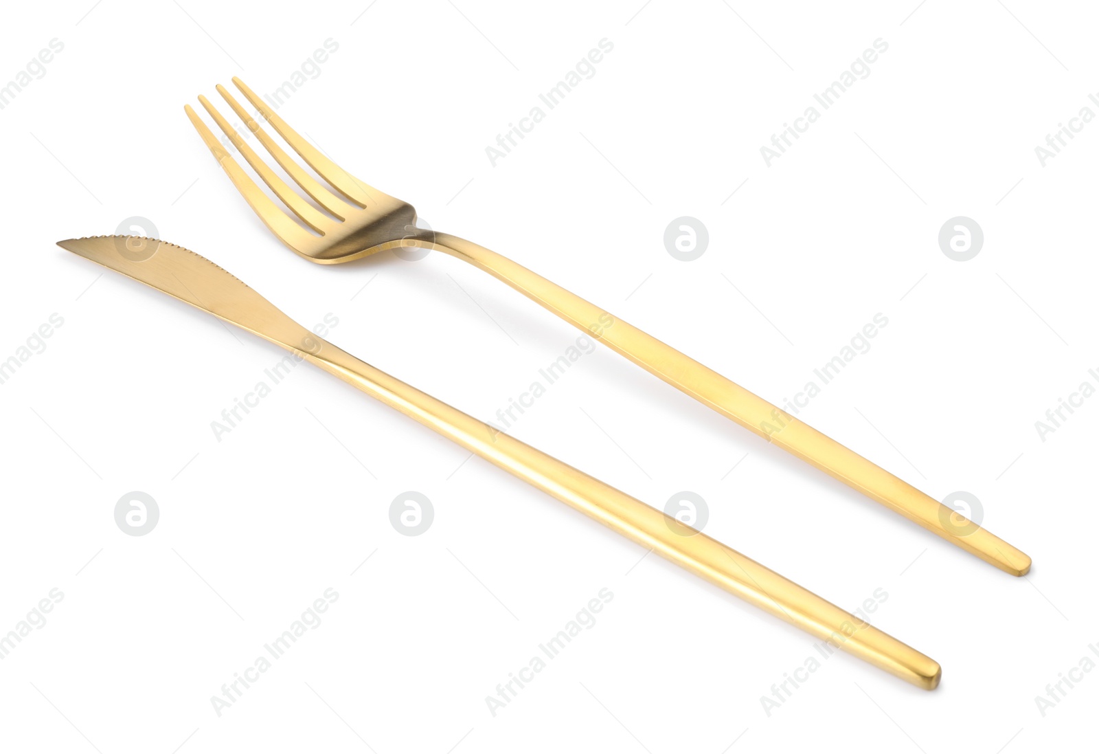 Photo of Shiny golden fork and knife isolated on white. Luxury cutlery