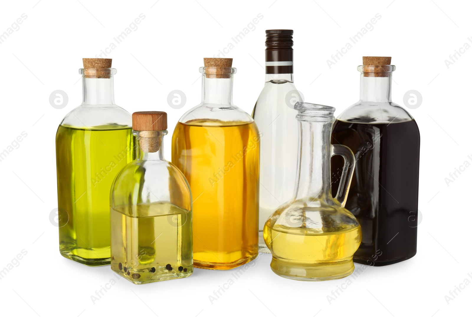 Photo of Vegetable fats. Glassware of different cooking oils isolated on white