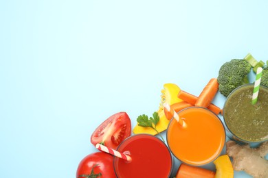 Photo of Delicious juices and fresh ingredients on light blue background, flat lay. Space for text