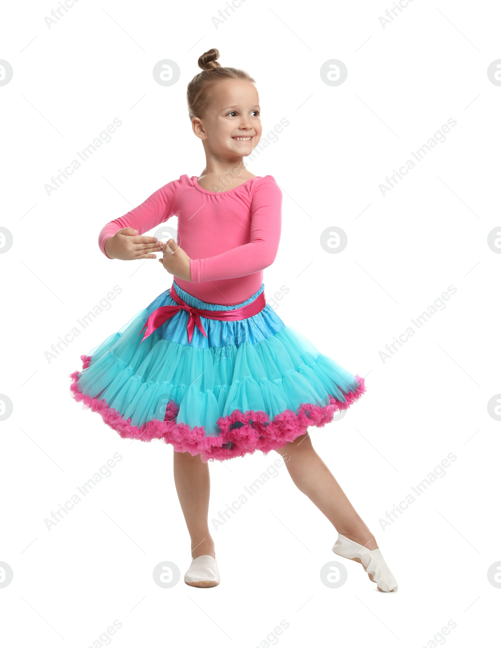 Photo of Cute little girl in costume dancing on white background