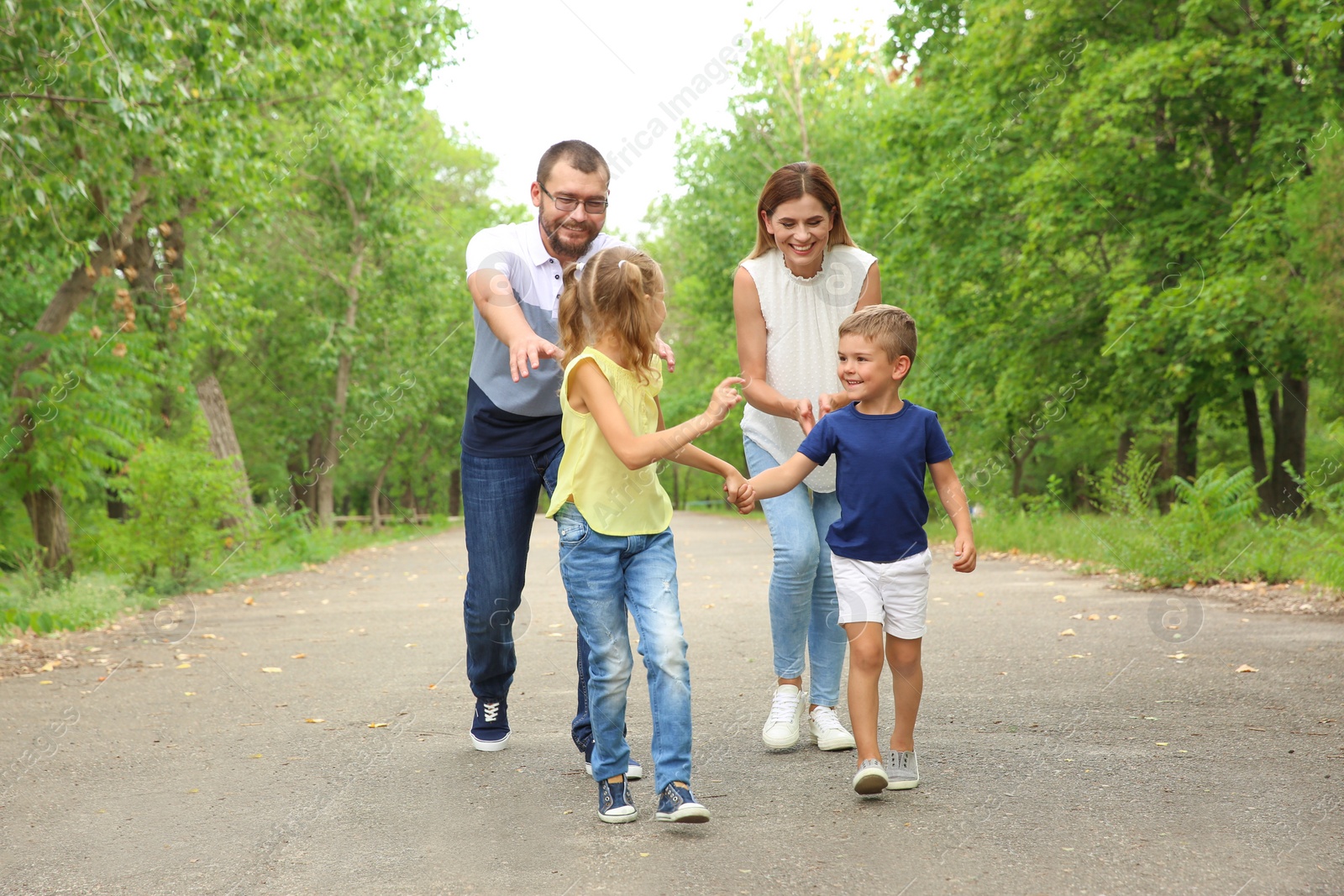 Photo of Happy family spending time together with their children outdoors