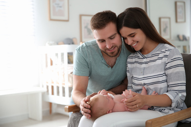 Happy couple with their newborn baby at home