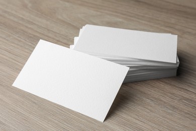 Photo of Blank business cards on wooden table. Mockup for design