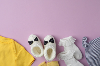 Photo of Flat lay composition with child's clothes on violet background, space for text