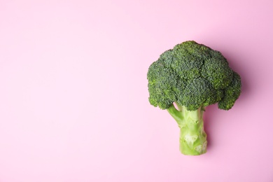 Photo of Fresh green broccoli on color background, top view. Space for text