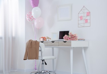 Photo of Beautiful flowers, gifts and balloons on white table in room. Happy birthday greetings