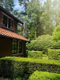 Photo of Beautiful view of house and garden on sunny day