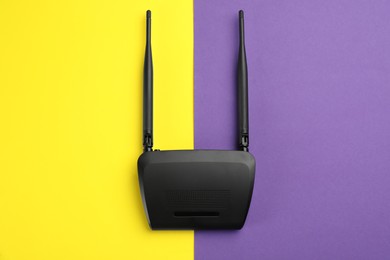 Photo of Modern Wi-Fi router on color background, top view