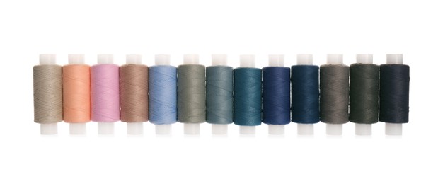 Set of colorful sewing threads on white background