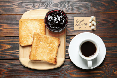 Photo of Flat lay composition with crispy toasts on wooden table. Delicious breakfast