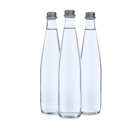 Photo of Glass bottles with soda water on white background