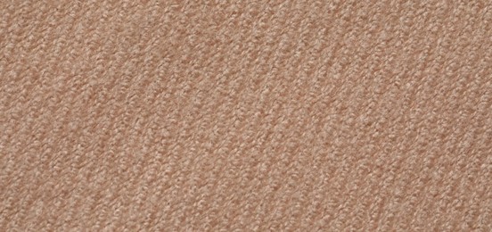 Photo of Texture of soft beige fabric as background, closeup