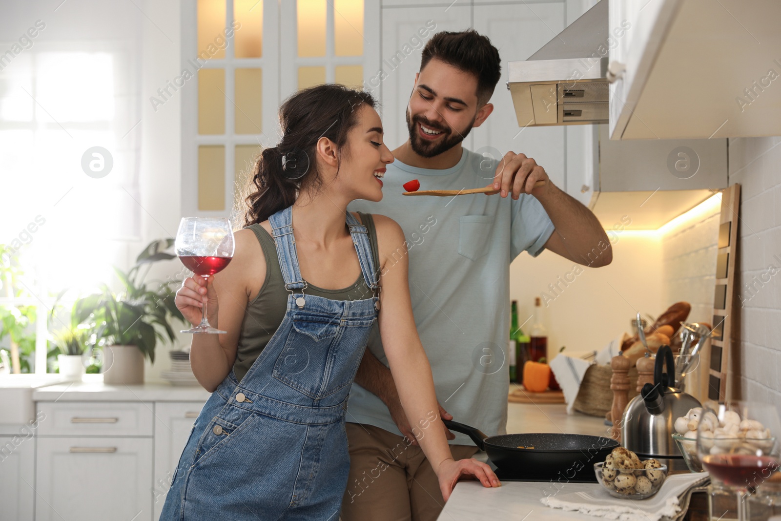 Photo of Lovely young couple cooking together in kitchen