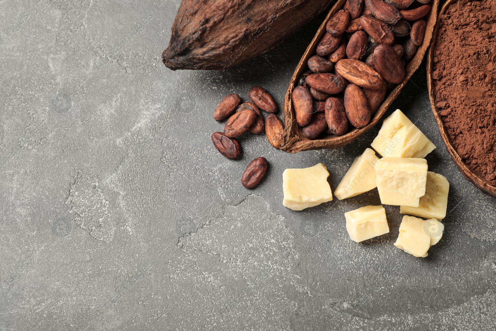 Photo of Flat lay composition with organic cocoa butter on grey table. Space for text