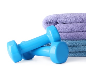 Photo of Stylish dumbbells and towels on white background. Home fitness