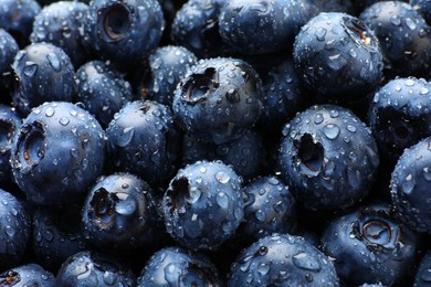Wet fresh blueberries as background, closeup view