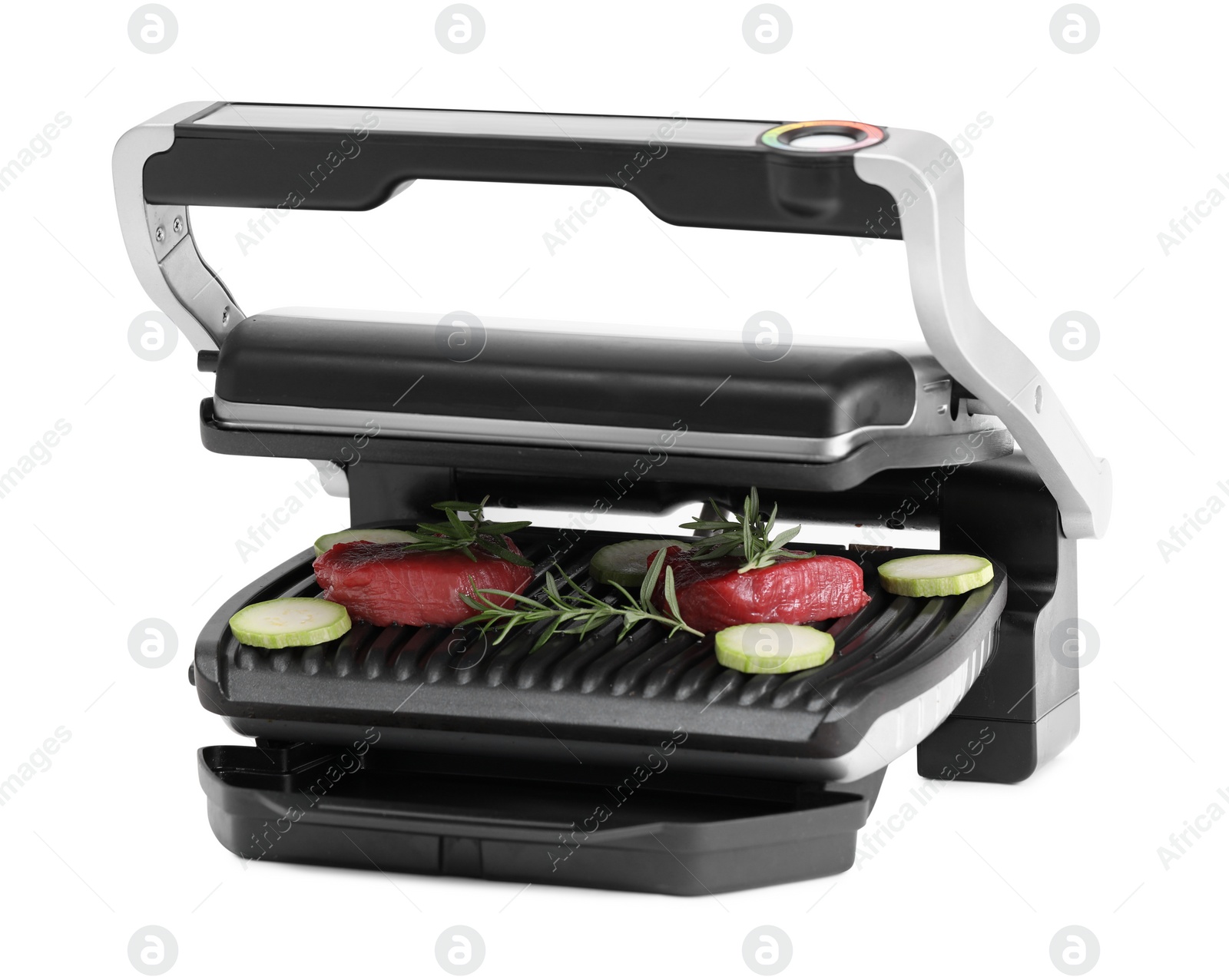 Photo of Electric grill with raw meat, zucchini and rosemary isolated on white