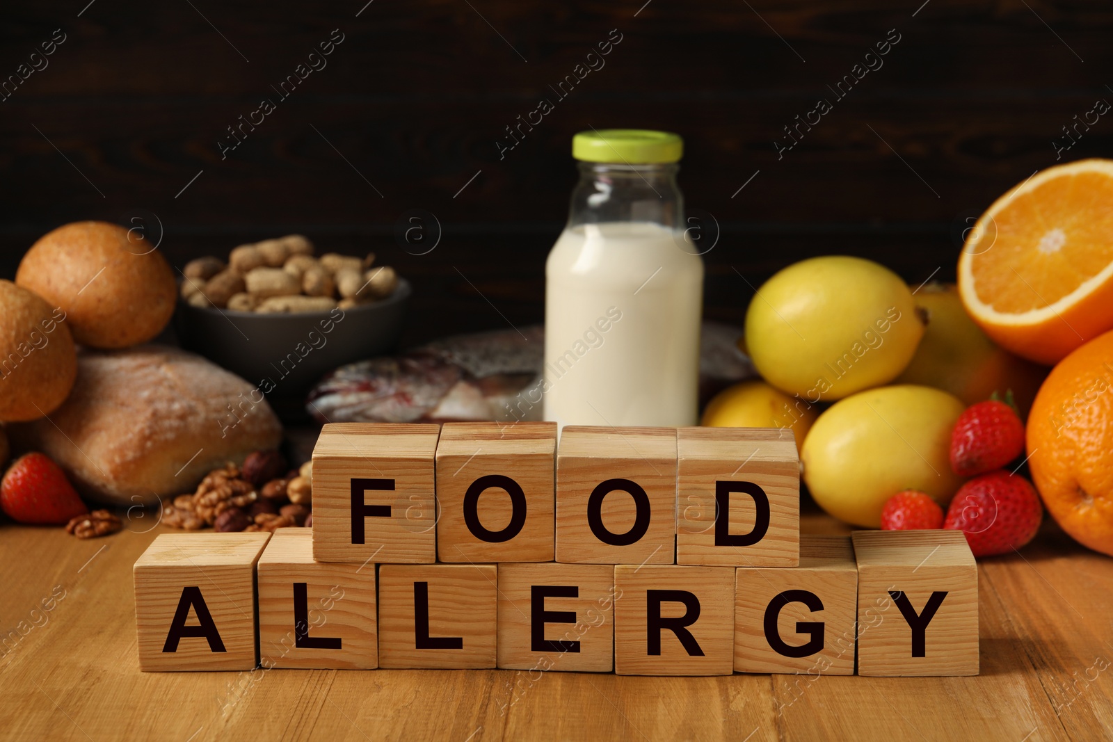 Image of Food allergy. Different fresh products and cubes on wooden table