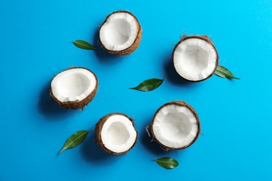 Photo of Flat lay composition with coconuts on color background