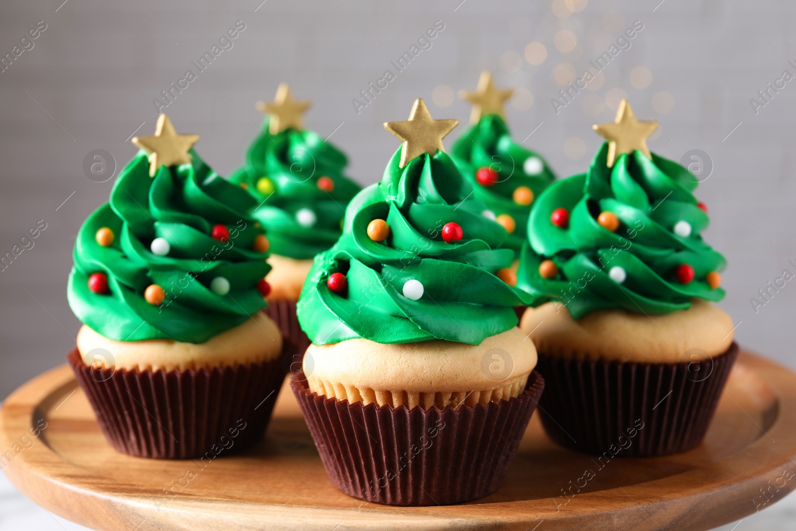 Photo of Christmas tree shaped cupcakes on wooden board