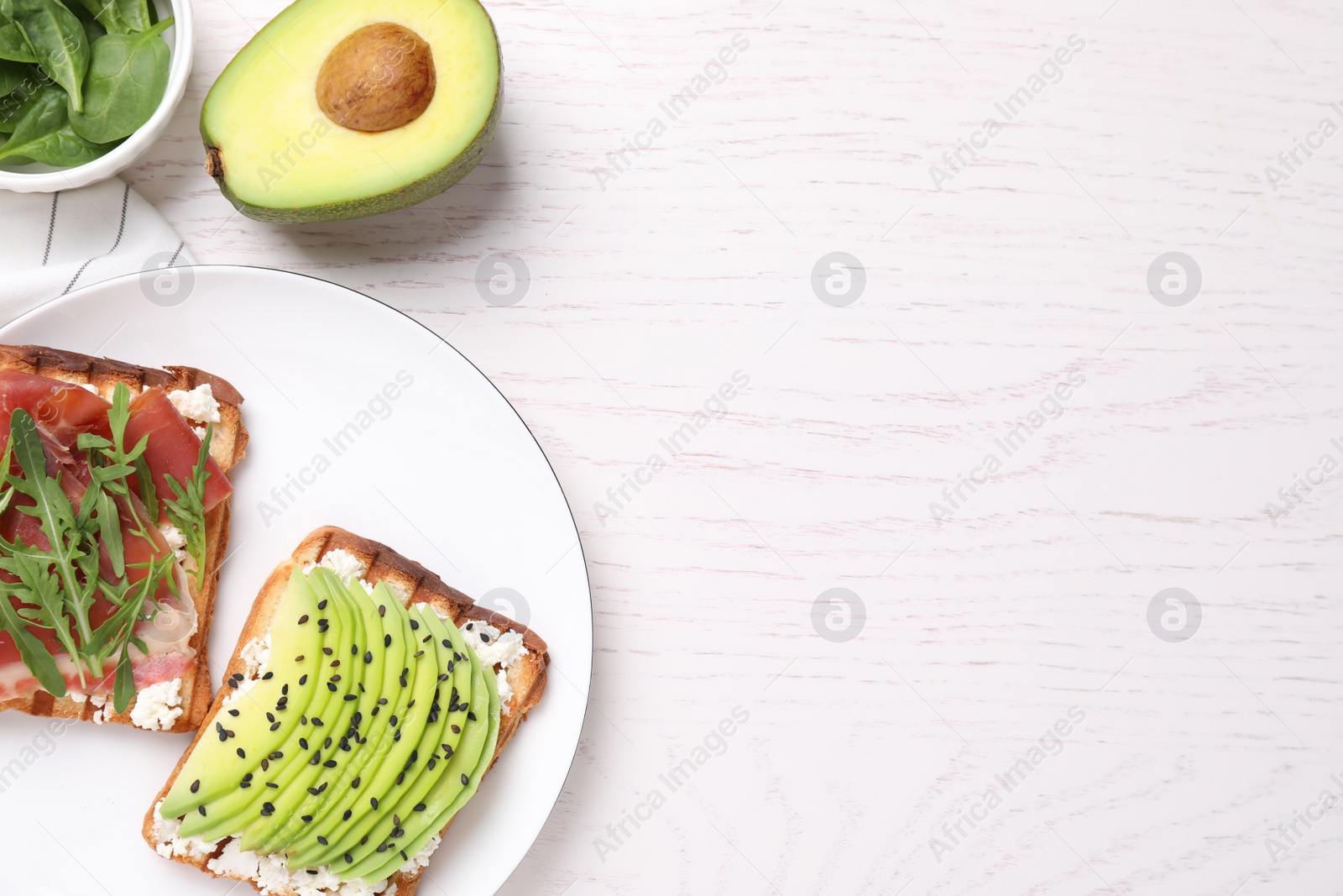 Photo of Different tasty sandwiches on white wooden table, flat lay. Space for text