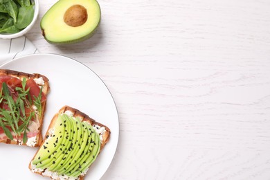 Different tasty sandwiches on white wooden table, flat lay. Space for text