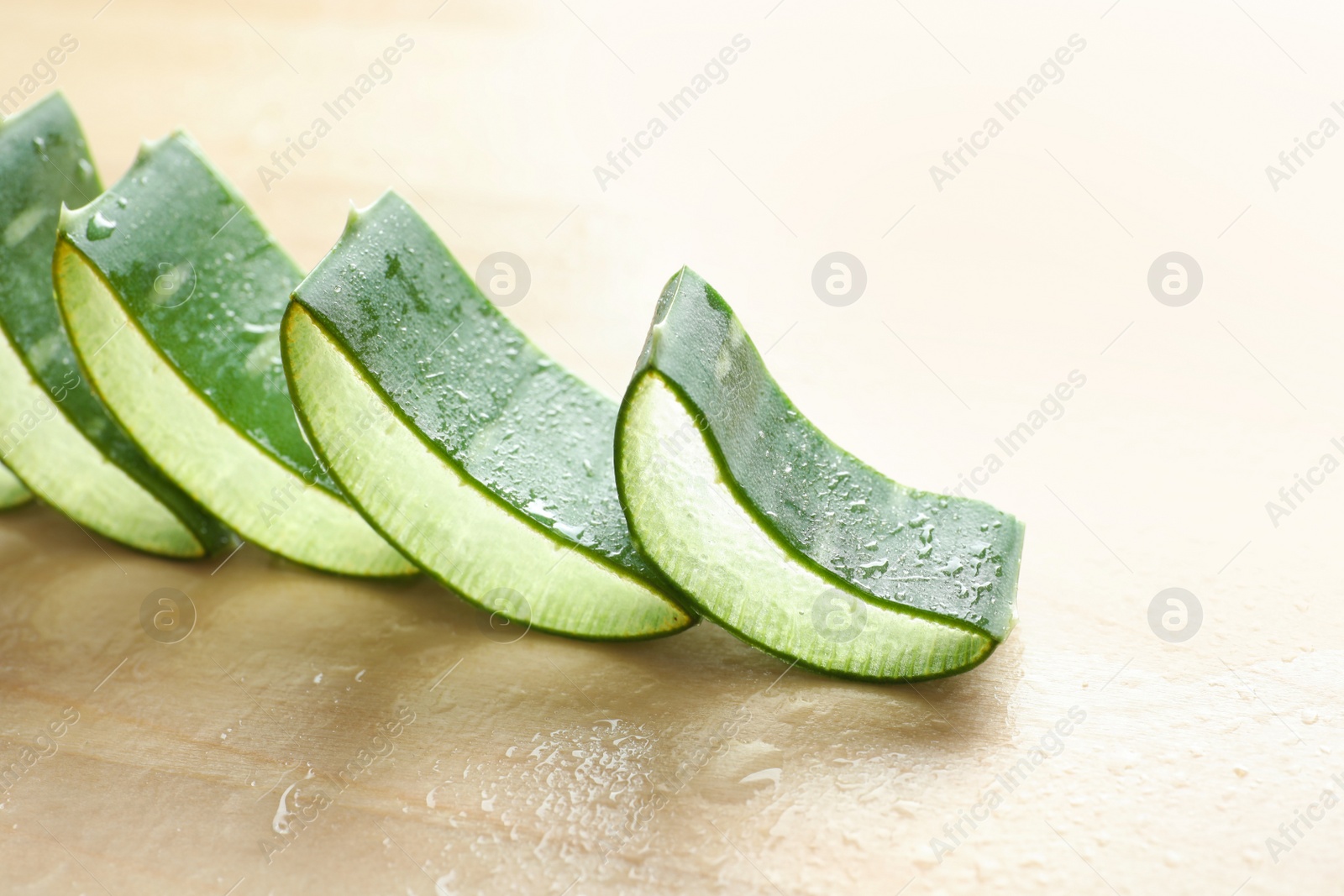 Photo of Fresh sliced aloe vera leaves on light table