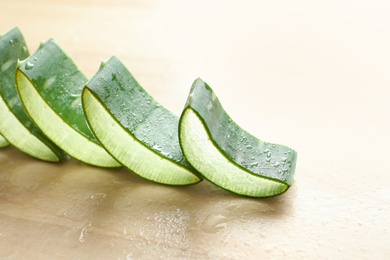 Photo of Fresh sliced aloe vera leaves on light table