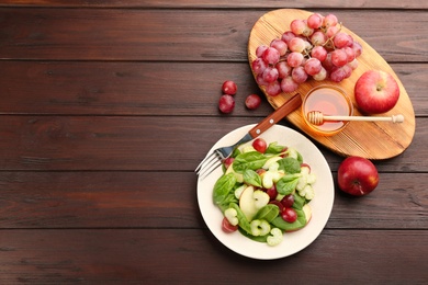 Delicious fresh celery salad served on wooden table, flat lay. Space for text