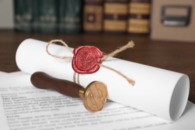 Documents and stamp on wooden table, closeup. Notary contract