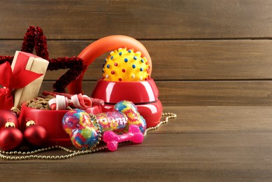 Photo of Different colorful pet shop goods on wooden background, space for text