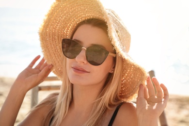 Beautiful woman wearing sunglasses outdoors on sunny day