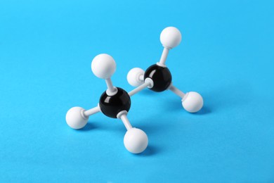 Molecule of alcohol on light blue background. Chemical model
