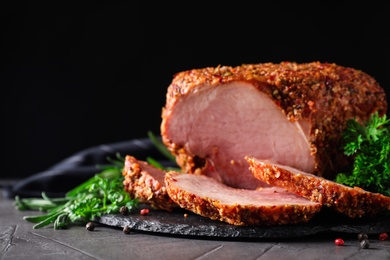 Photo of Homemade delicious ham on grey table, space for text. Festive dinner