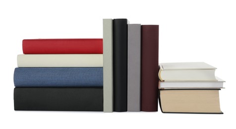 Photo of Many different books stacked on white background