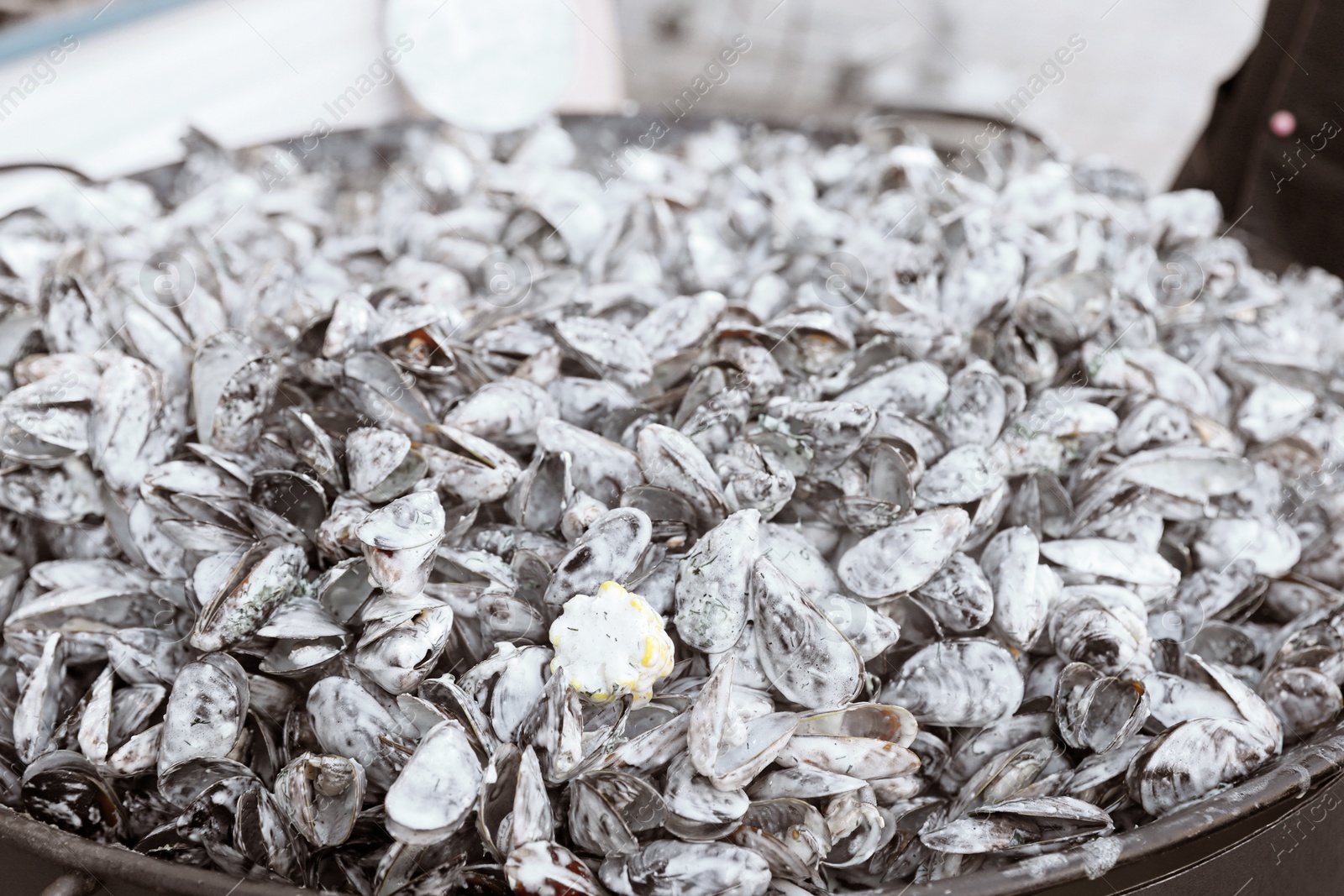 Photo of Delicious fresh mussels with sauce in pan, closeup