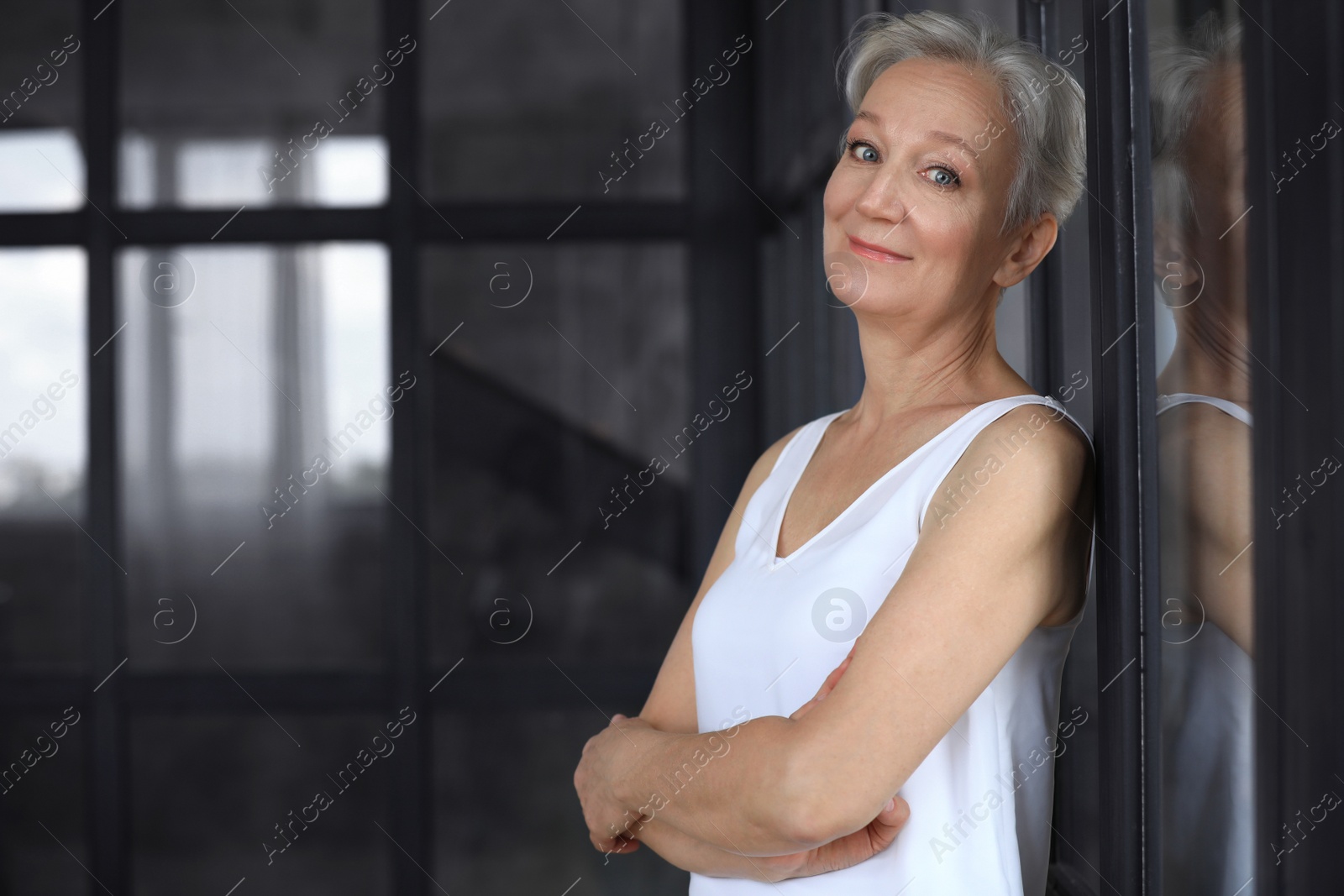 Photo of Portrait of happy mature woman indoors, space for text. Smart aging