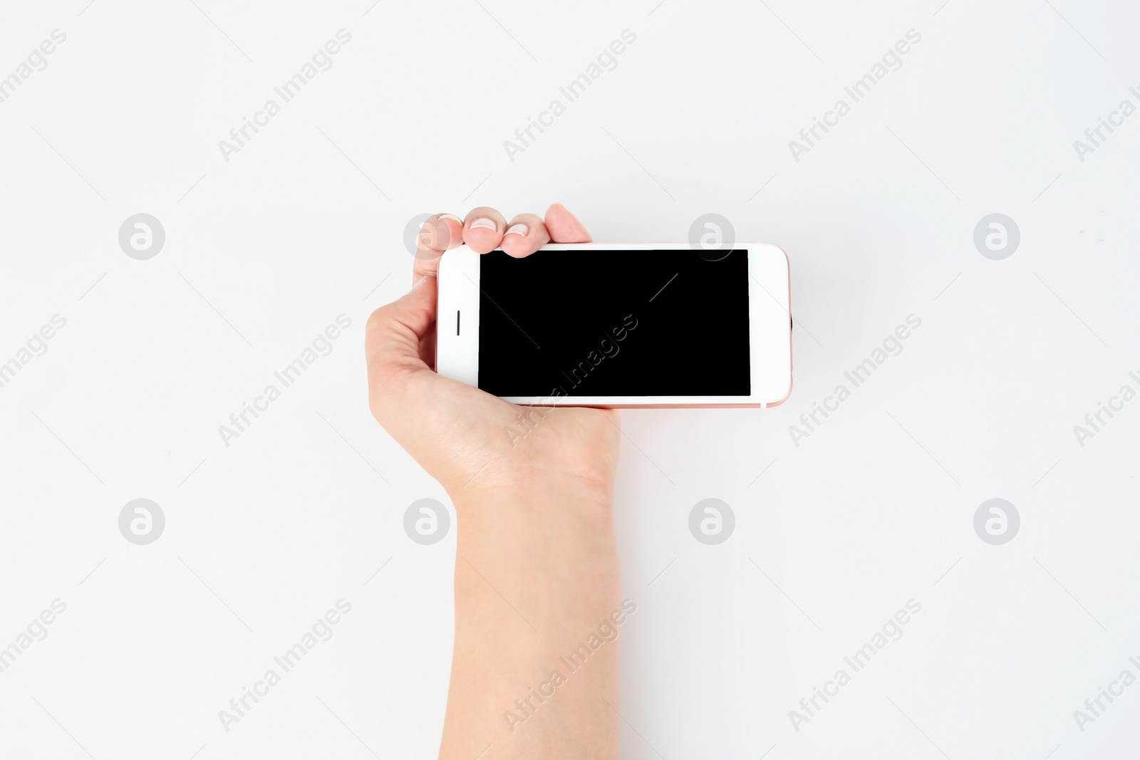 Photo of Young woman holding mobile phone with blank screen in hand on white background