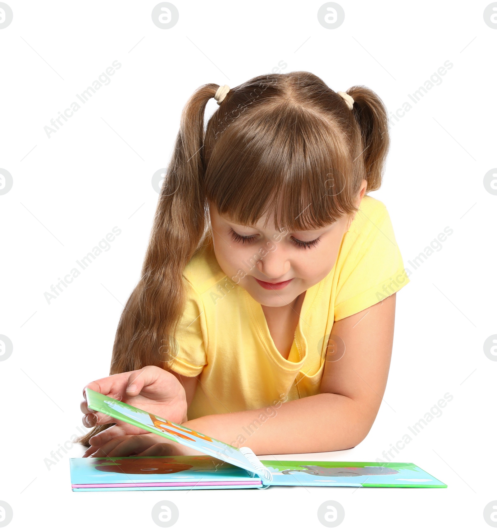 Photo of Portrait of cute little girl reading book on white background