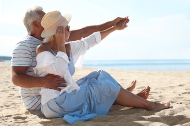 Mature couple spending time together on sea beach