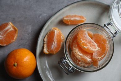 Photo of Fresh ripe tangerines on grey table, flat lay