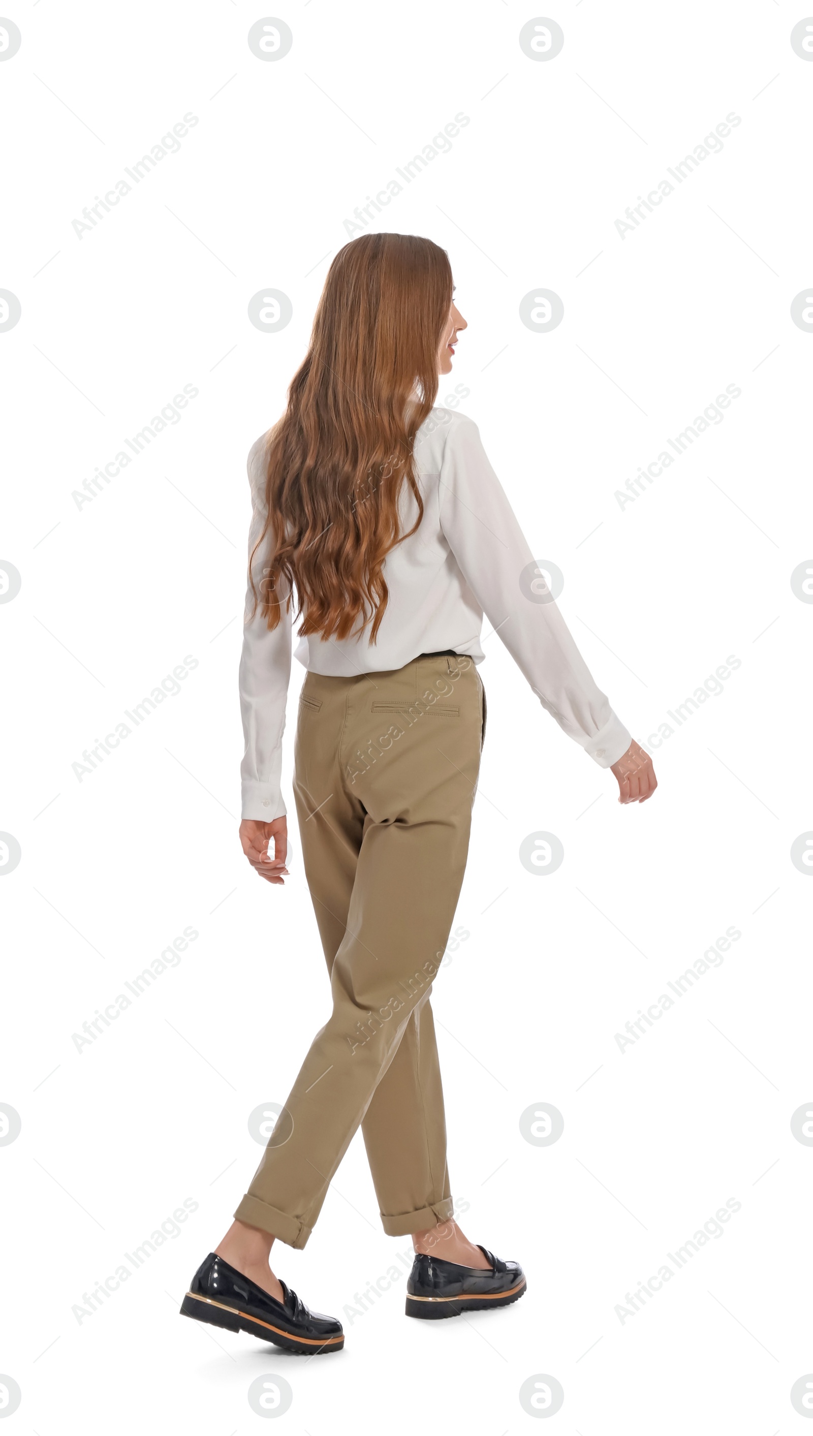 Photo of Young woman in casual outfit walking on white background