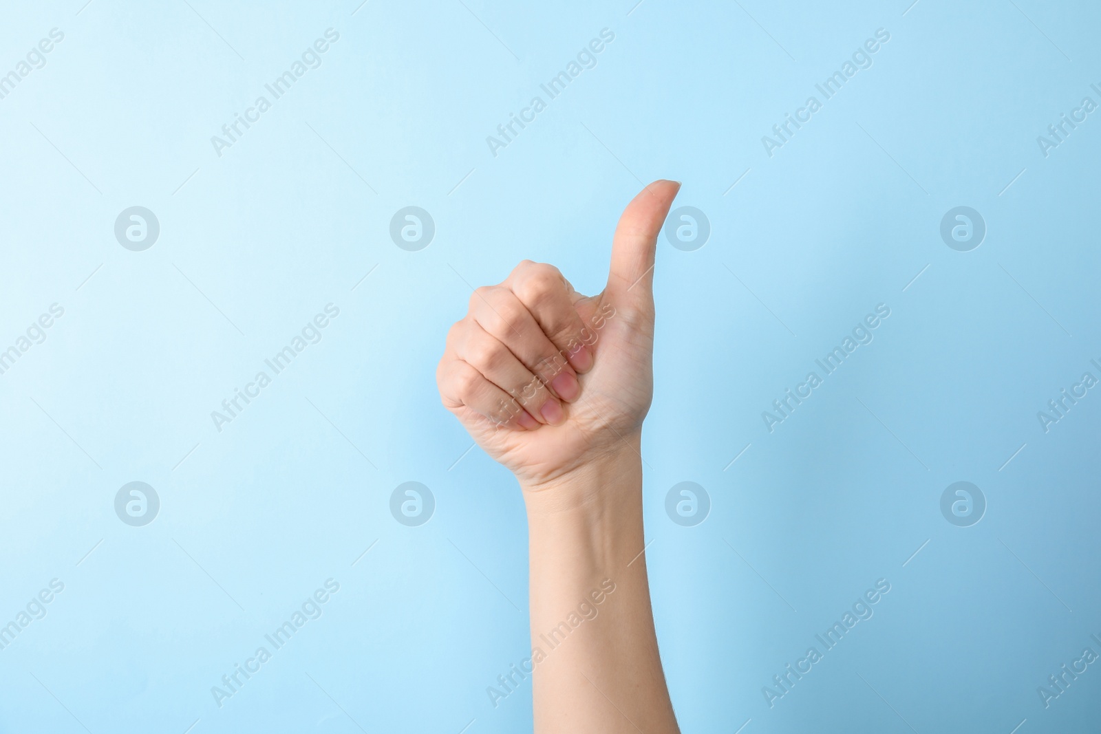 Photo of Woman showing number ten on color background, closeup. Sign language