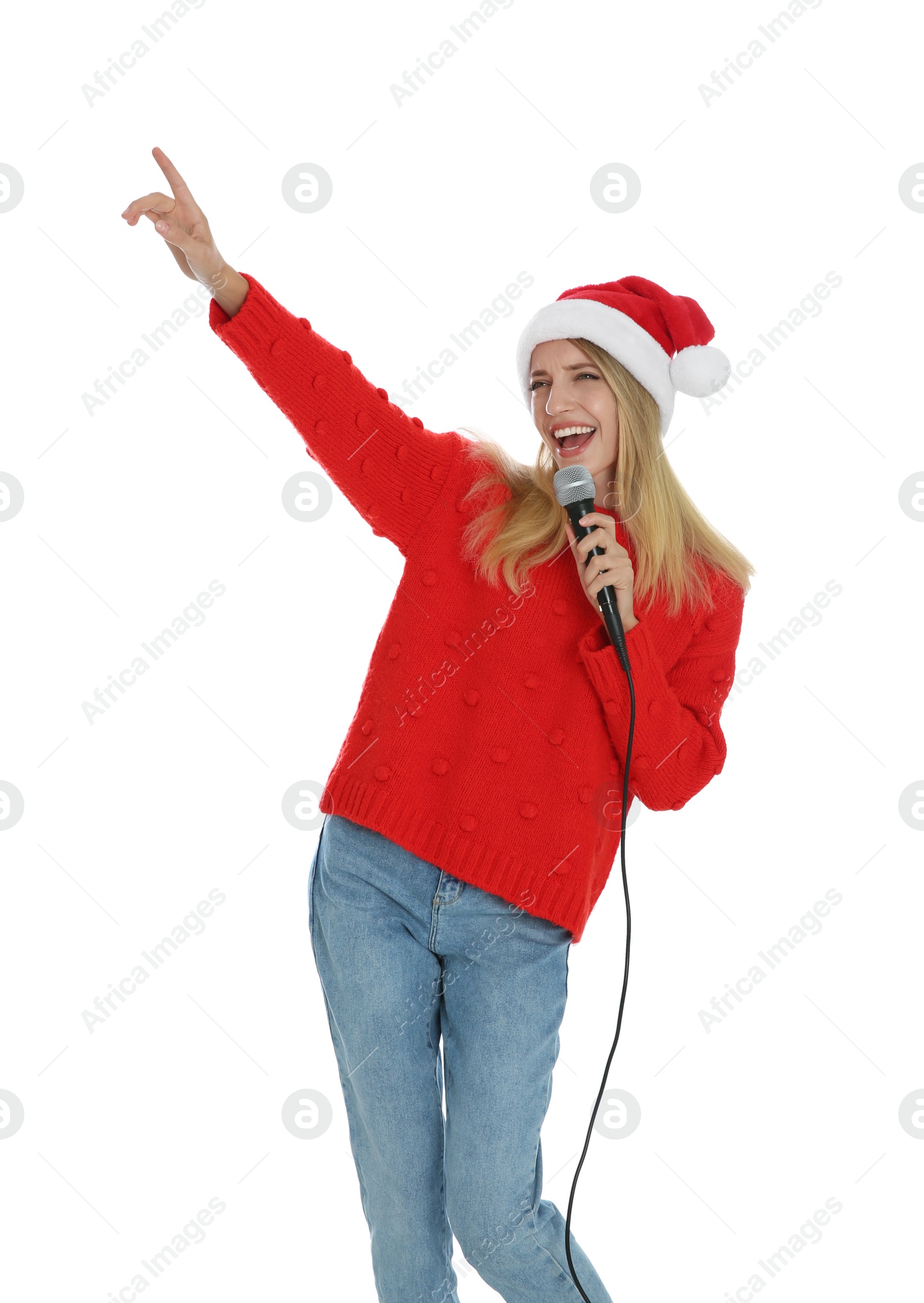 Photo of Happy woman in Santa Claus hat singing with microphone on white background. Christmas music