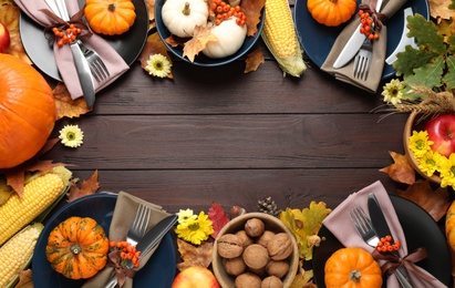Photo of Table setting with autumn vegetables and fruits on wooden background, flat lay. Thanksgiving day celebration
