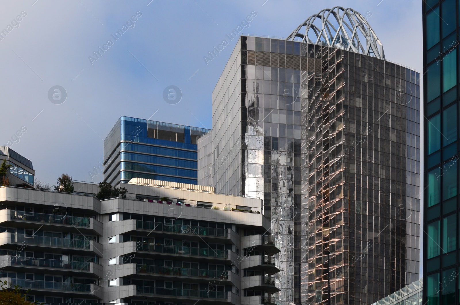 Photo of Exterior of different modern skyscrapers against blue sky