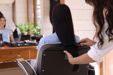 Photo of Hairdresser working with client in beauty salon